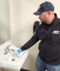 Photo of ASI Environmental Residential Manager Performing a Well Water Test from an Indoor Faucet
